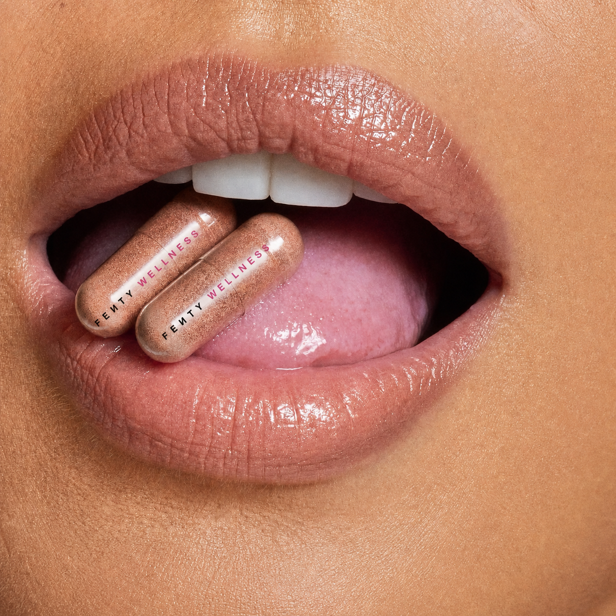 Fenty Wellness nutraceutical capsules held at the mouth